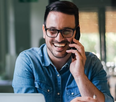 dark haired man on the phone